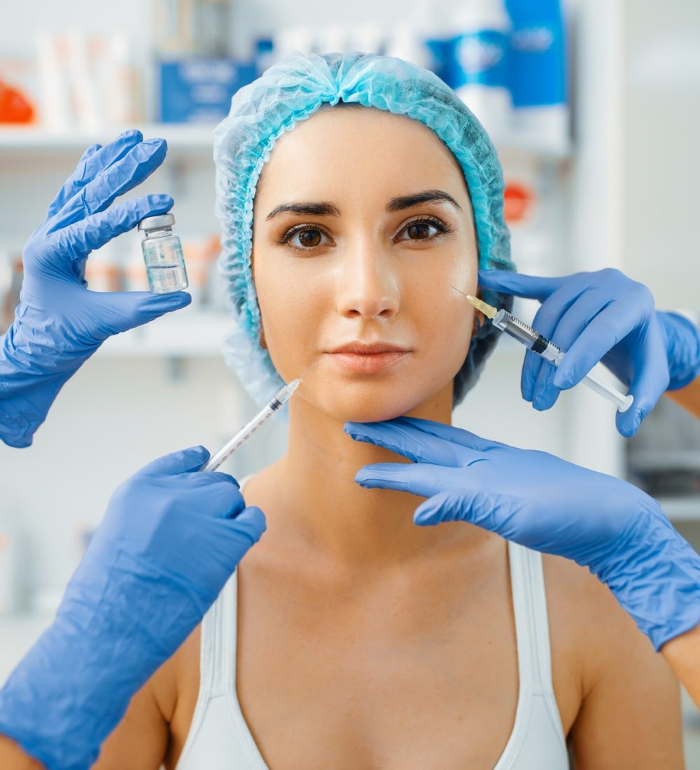cosmetician-hands-with-botox-and-female-patient